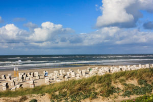Clouds, beach chairs and waves on the beach of the island Wangerooge, Clouds, beach chairs and waves on the beach of the island Wangerooge,